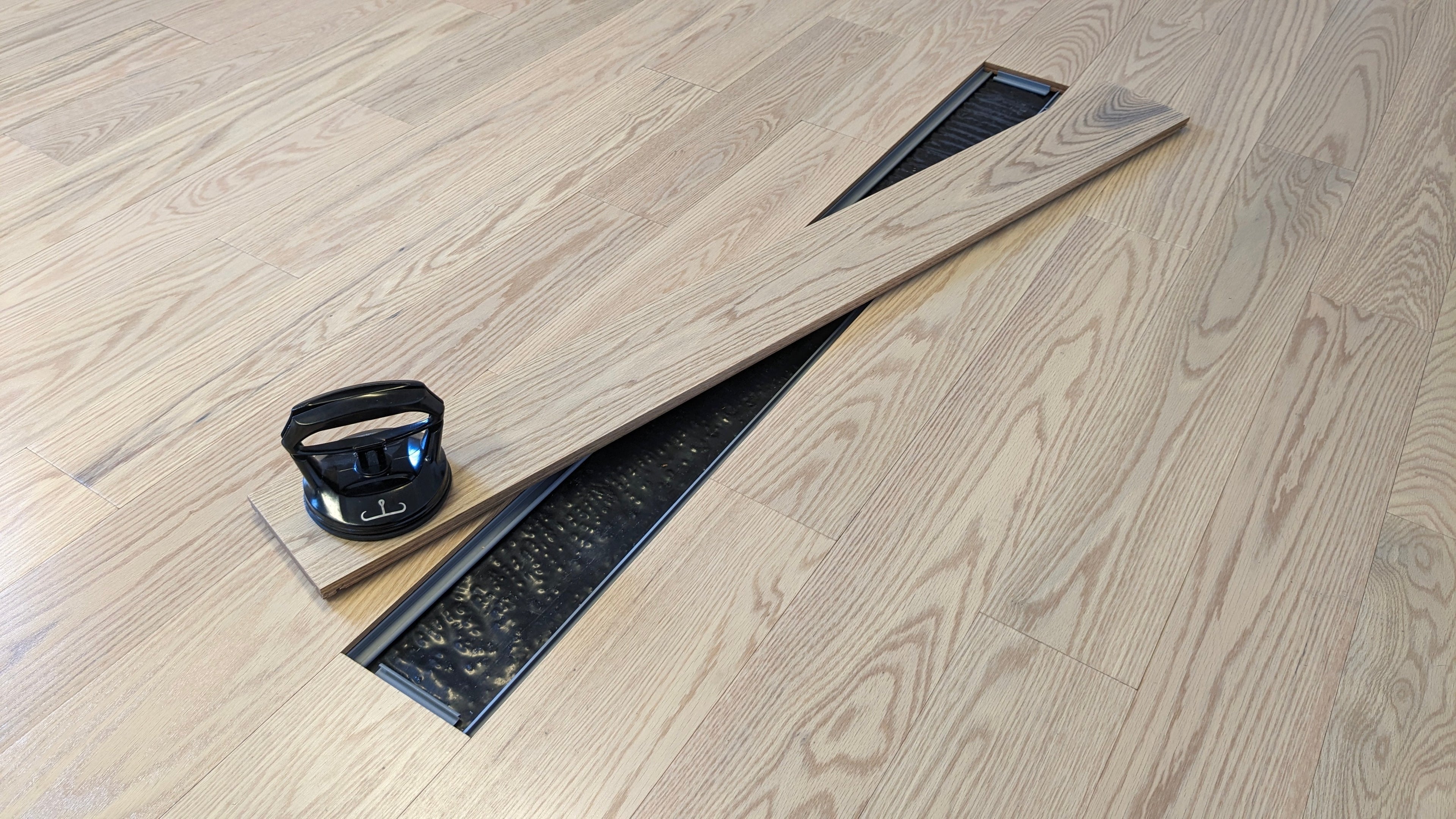 Smarter hardwood flooring with tool-free installation, featuring easily replaceable planks and sleek design for modern tech homes.