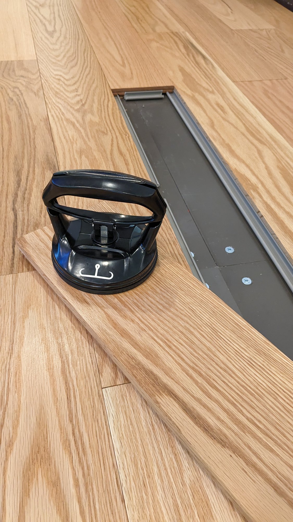 A suction cup on a steller American Oak floor over a raised panel floor