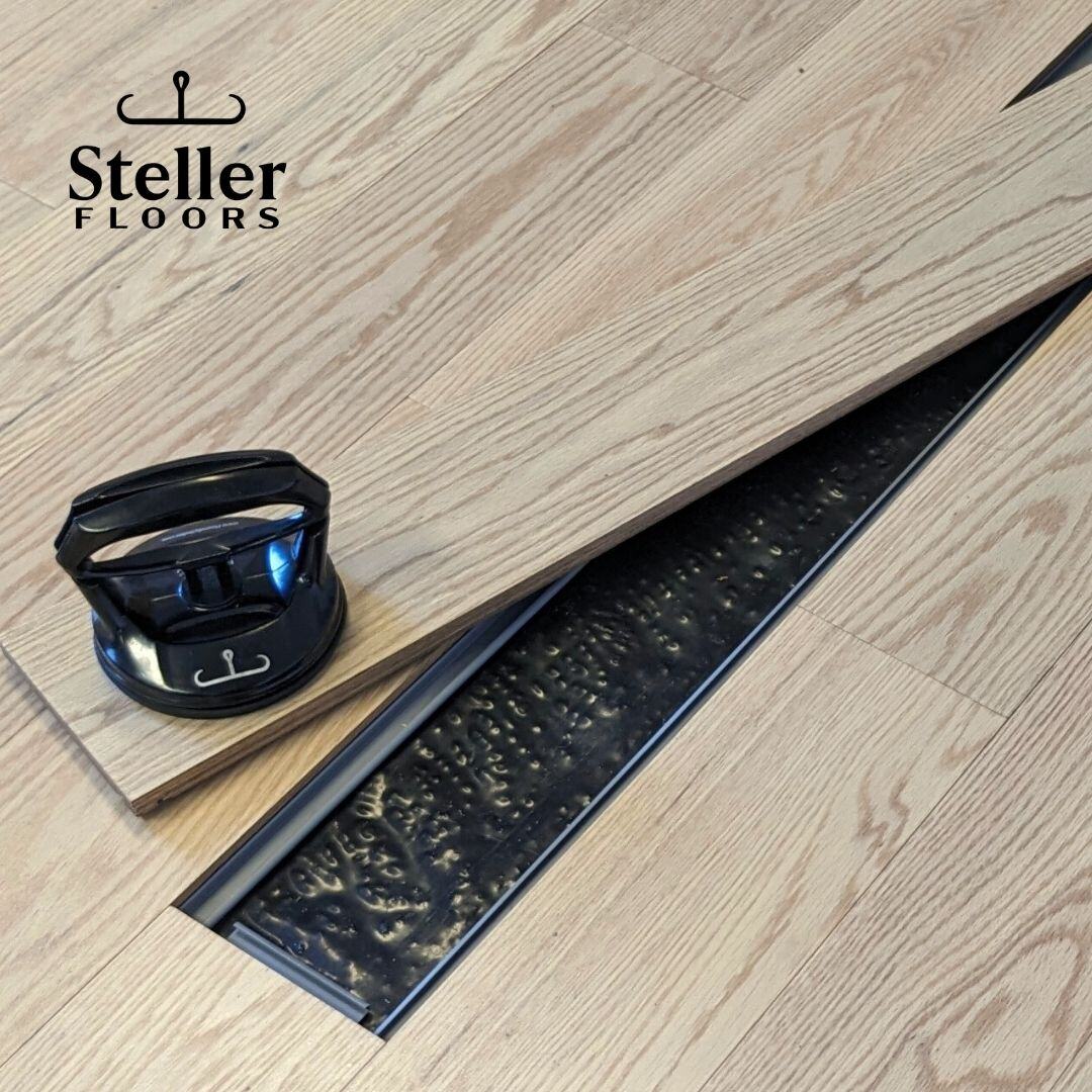 Steller Floors Whitewash American Oak with a Plank Removed using a Suction Cup